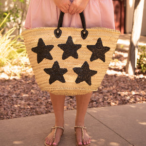 Girl holding Large Straw Bag with Black Sequin Stars