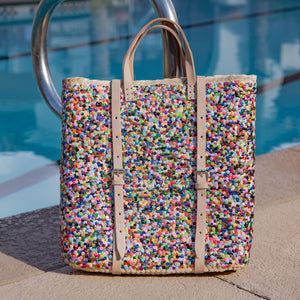 Straw Backpack with Multi-Colored Sequins sitting by a pool