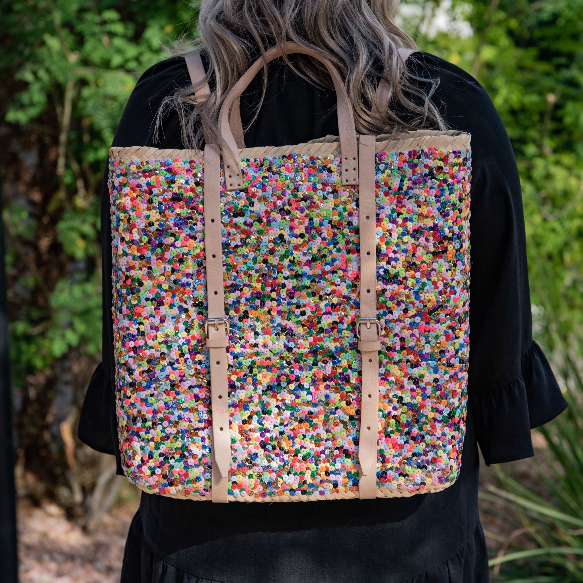 Woman wearing Straw Backpack with Multi-Colored Sequin