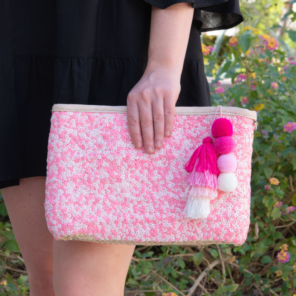 Girl holding straw clutch with pink sequins