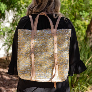 Woman wearing Straw Backpack with Silver and Gold Sequins